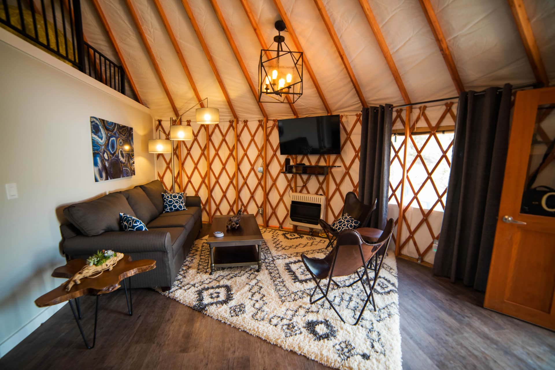 Colorado Yurt interior with modern living room, vaulted ceiling, and sleeping loft